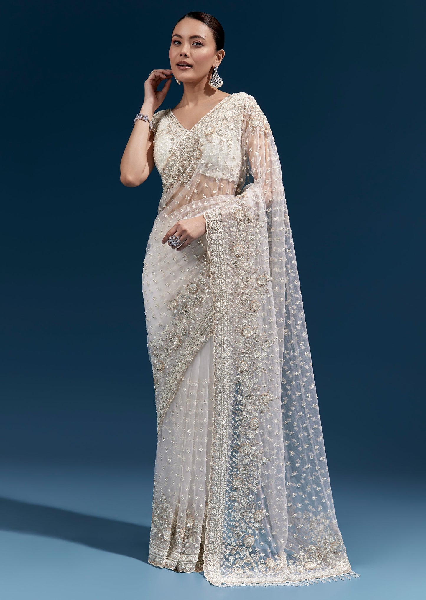 Off White Heavy Embroidered Net Saree With Scalloped Border And Tasselled Pallu