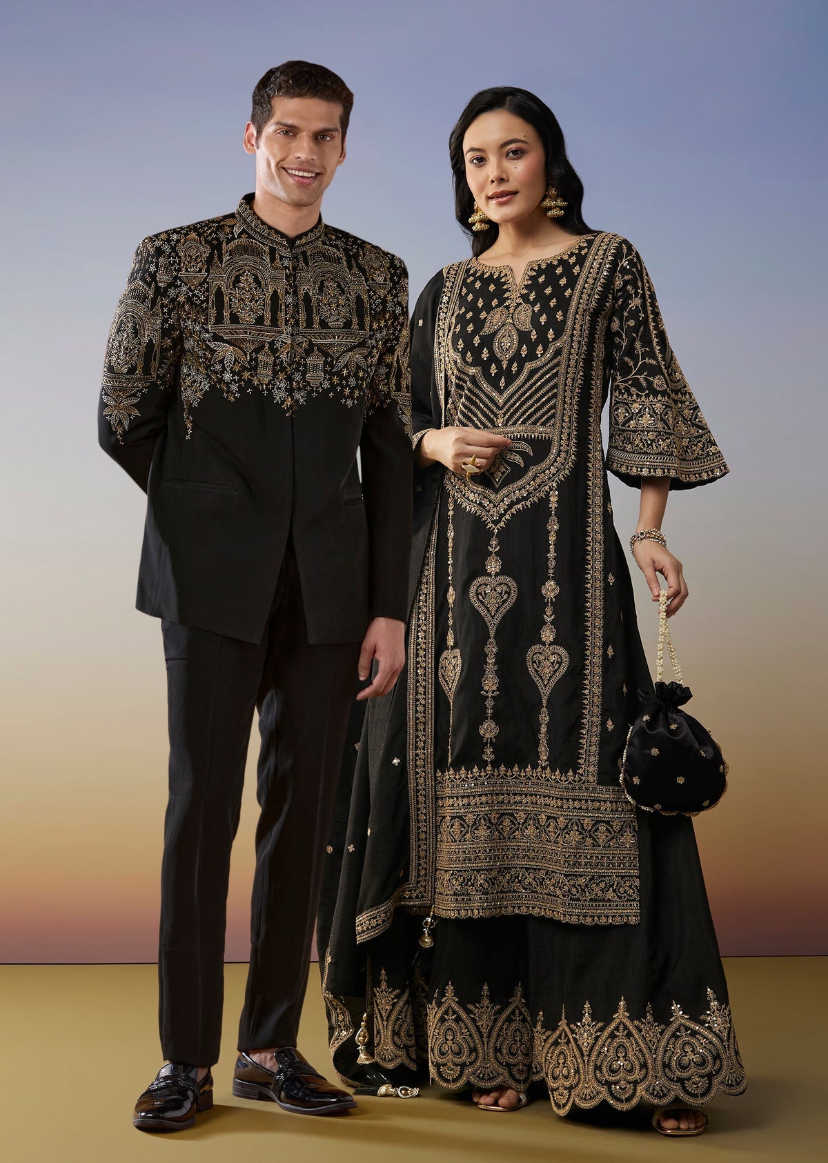 Bold Festive Couple Set – Black Silk Palazzo Suit With Zari Thread And Sequins Work For Her And Black Suiting Jodhpuri Pant Set With Embroidery For Him