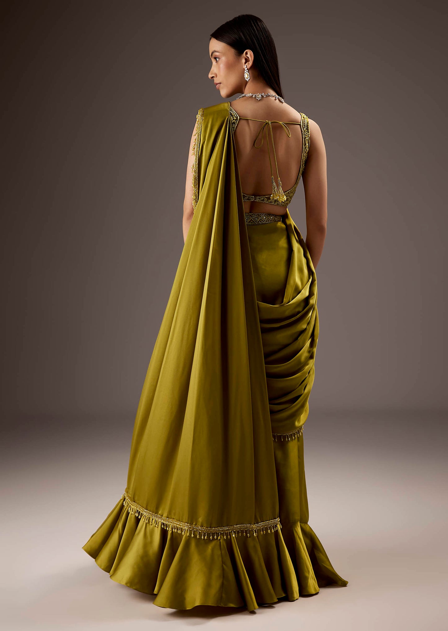 Green Silk Saree With Elegant Bead Work And Frills