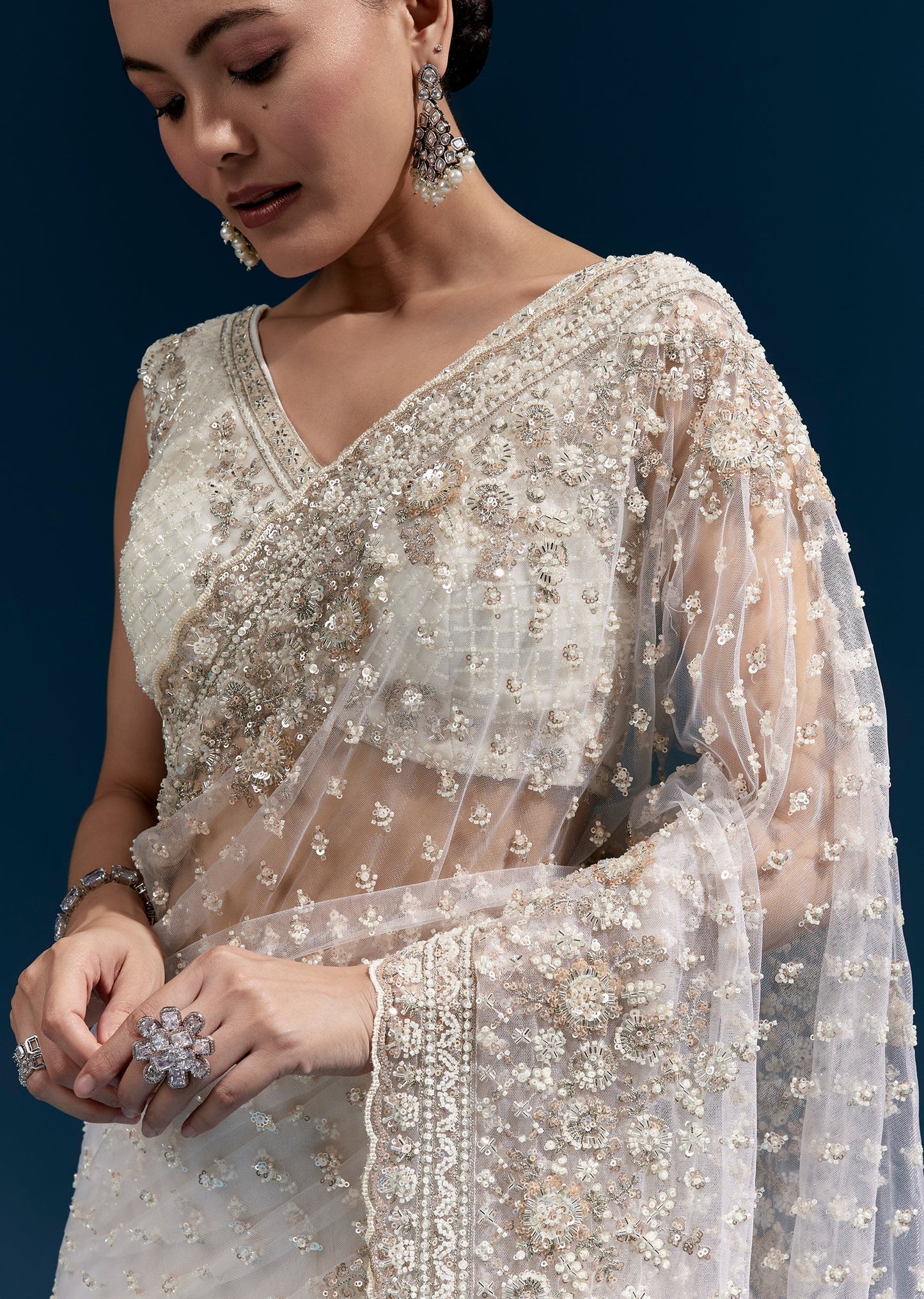 Off White Heavy Embroidered Net Saree With Scalloped Border And Tasselled Pallu