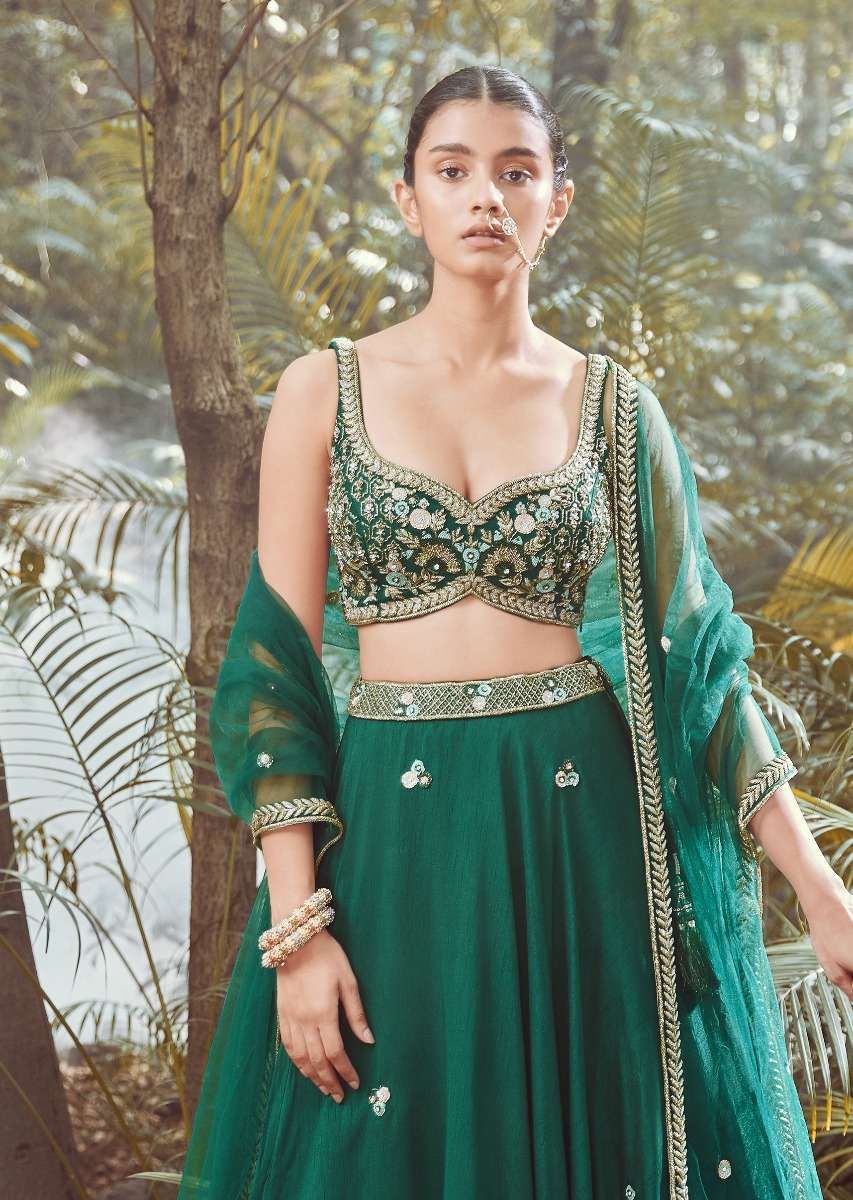 Srushti Porey In Pine Green Lehenga Choli In Raw Silk With Butti Work And Heavy Hand Embroidery In Mughal Motifs On The Choli