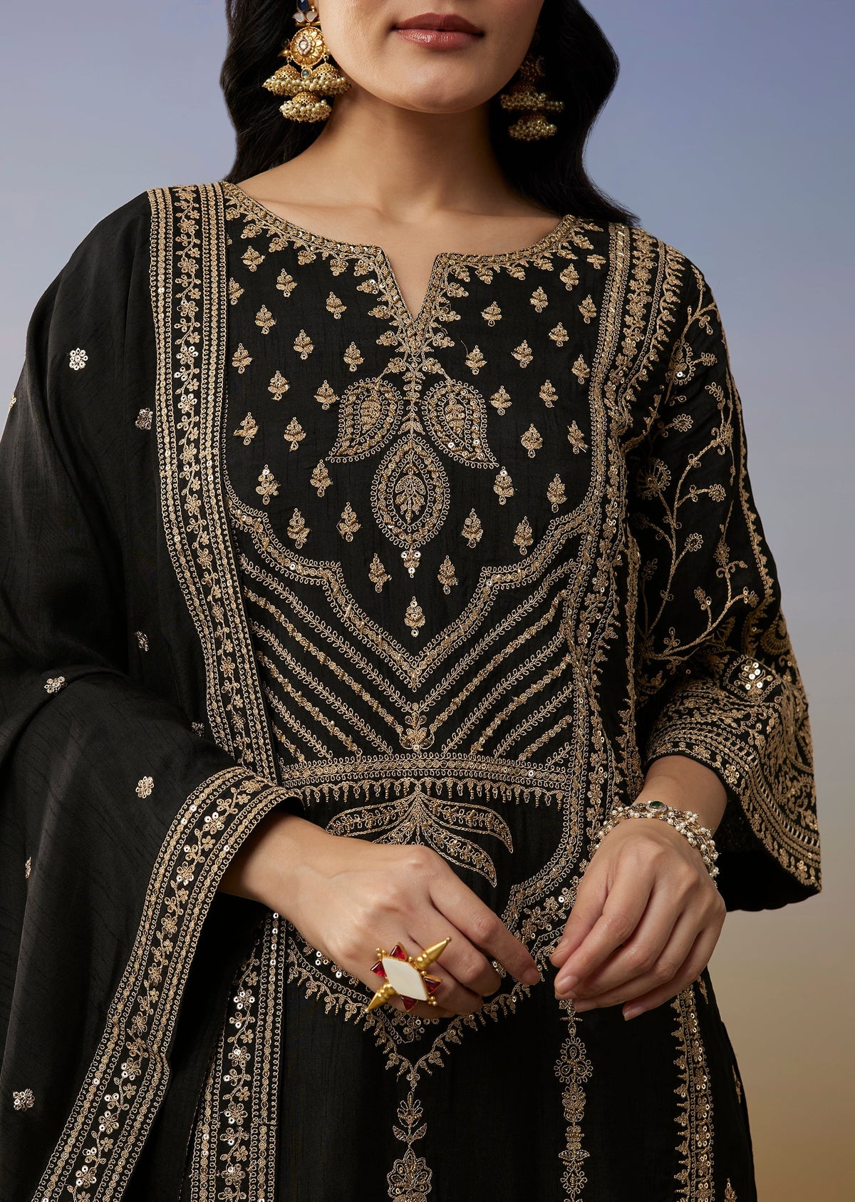 Bold Festive Couple Set – Black Silk Palazzo Suit With Zari Thread And Sequins Work For Her And Black Suiting Jodhpuri Pant Set With Embroidery For Him